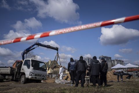 Forensic scientists and police inspect the bodies of local residents after removing them from a mass grave in Bucha, on the outskirts of Kyiv, Ukraine, on April 11.