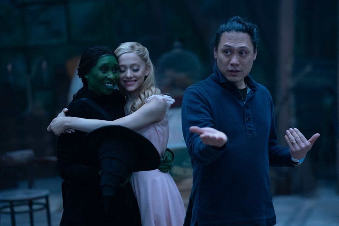 Cynthia Erivo is Elphaba, Ariana Grande is Glinda and director Jon M. Chu on the set of 