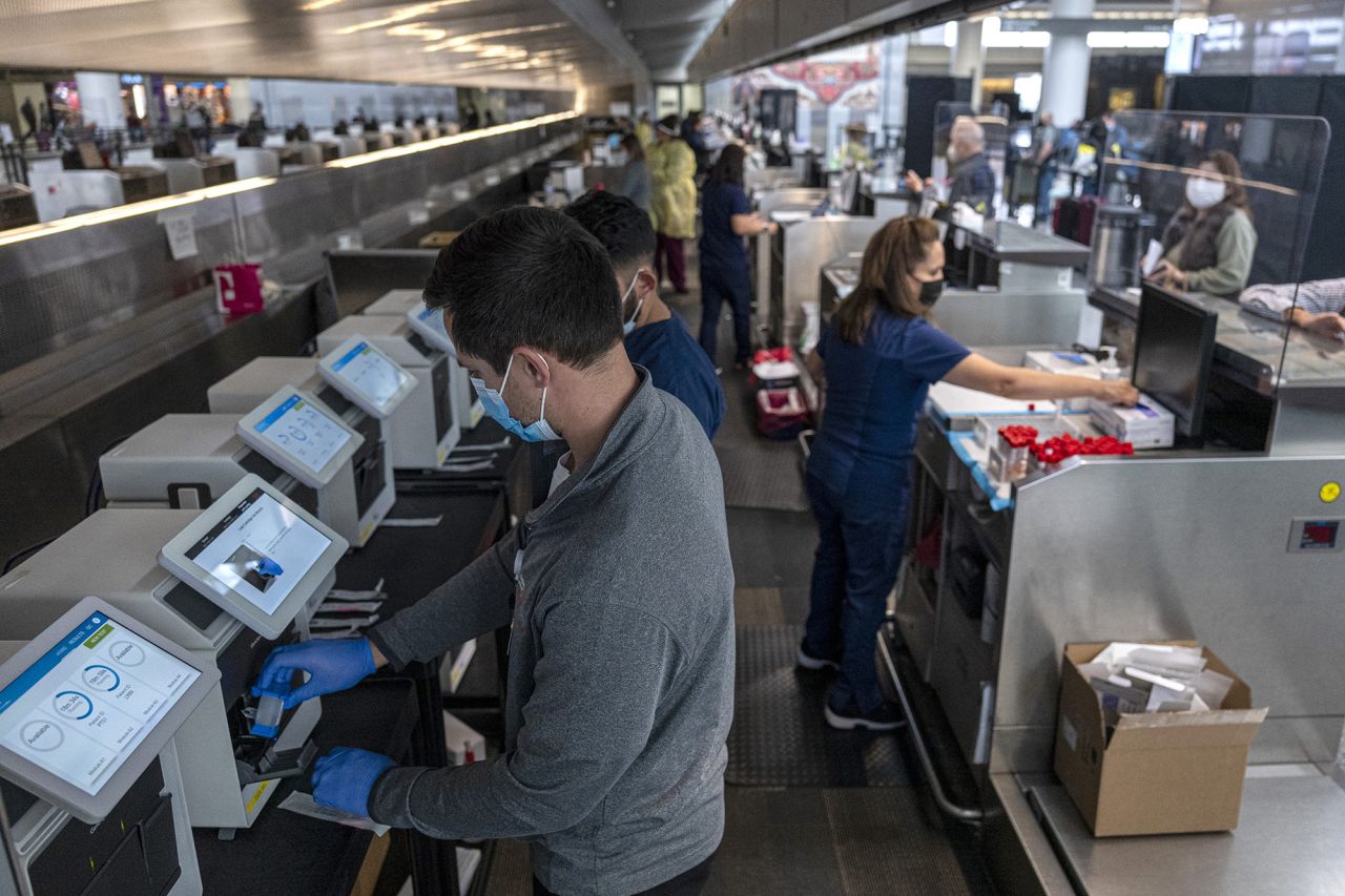 Medical workers at a Dignity Health-GoHealth Urgent Care Covid-19 testing site in the international terminal at San Francisco International Airport (SFO) in San Francisco, California, U.S., on Thursday, December 2nd, 2021.?