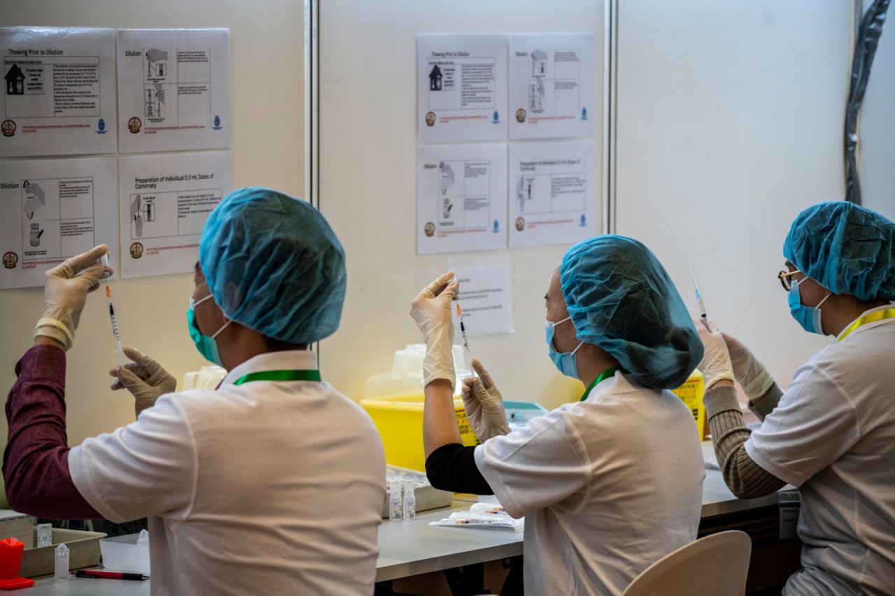 Pharmacists are seen at a vaccination center run by the University of Hong Kong on March 13.