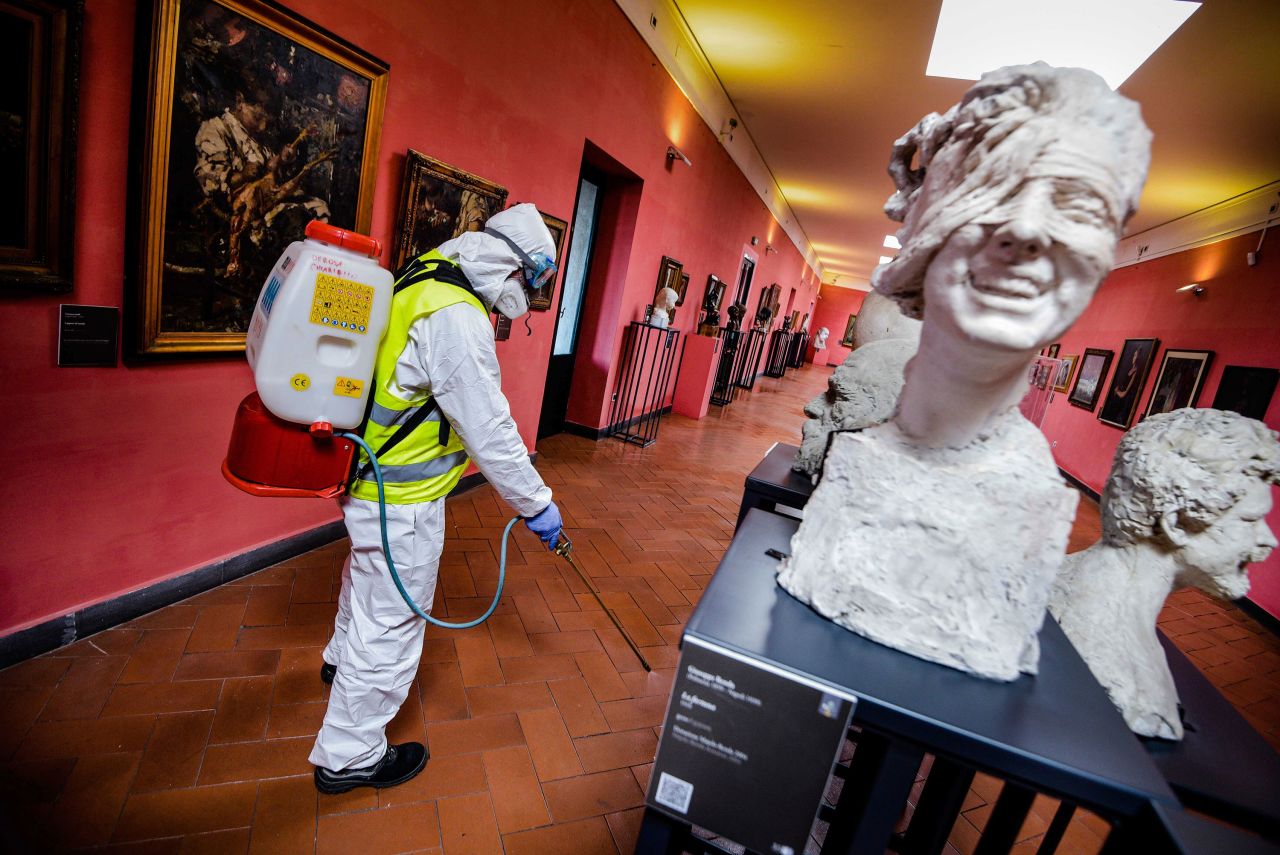 A worker sprays disinfectant in the museum hosted by the Maschio Angioino medieval castle in Naples, Italy on Tuesday. 