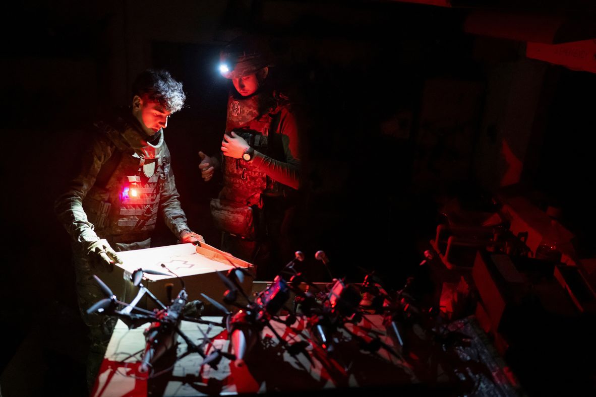 Ukrainian service members unpack a box next to drones at their position near Kupiansk, Ukraine, on Monday, June 23.