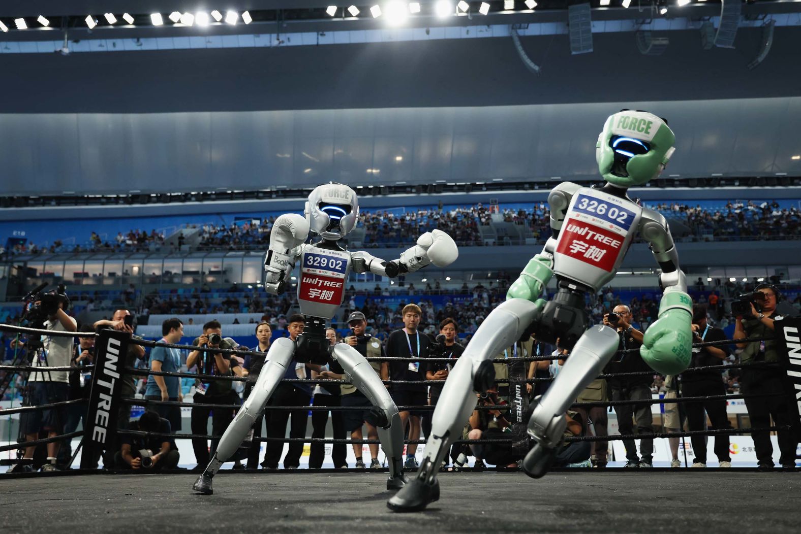 Humanoid robots fight during a kickboxing match on day two of the 2025 World Humanoid Robot Games in Beijing on Saturday, August 16.