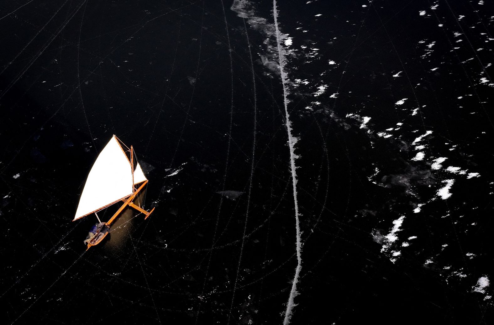 An antique wooden ice sailing yacht, built during the 1800s, is sailed on the frozen Hudson River near Athens, New York, on Saturday, January 25. The yacht is maintained and sailed by members of the Hudson River Ice Yacht Club.