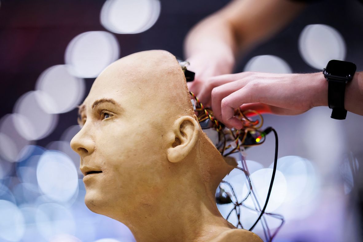 A man works on the electronics of Jules, a humanoid robot from Hanson Robotics that uses artificial intelligence, during the International Telecommunication Union AI for Good Global Summit in Geneva, Switzerland, on Tuesday, July 8.