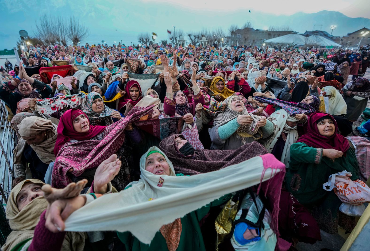 Kashmiri Muslims pray as the head priest displays a relic, believed to be a hair from the beard of the Prophet Mohammed, at the Hazratbal Shrine in Srinagar, India, on Thursday, February 8.