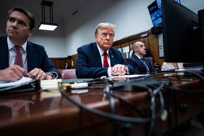 Former President Donald Trump (C) appears with his legal team Todd Blanche, and Emil Bove (R) ahead of the start of jury selection at Manhattan Criminal Court on April 15, 2024 in New York City. 