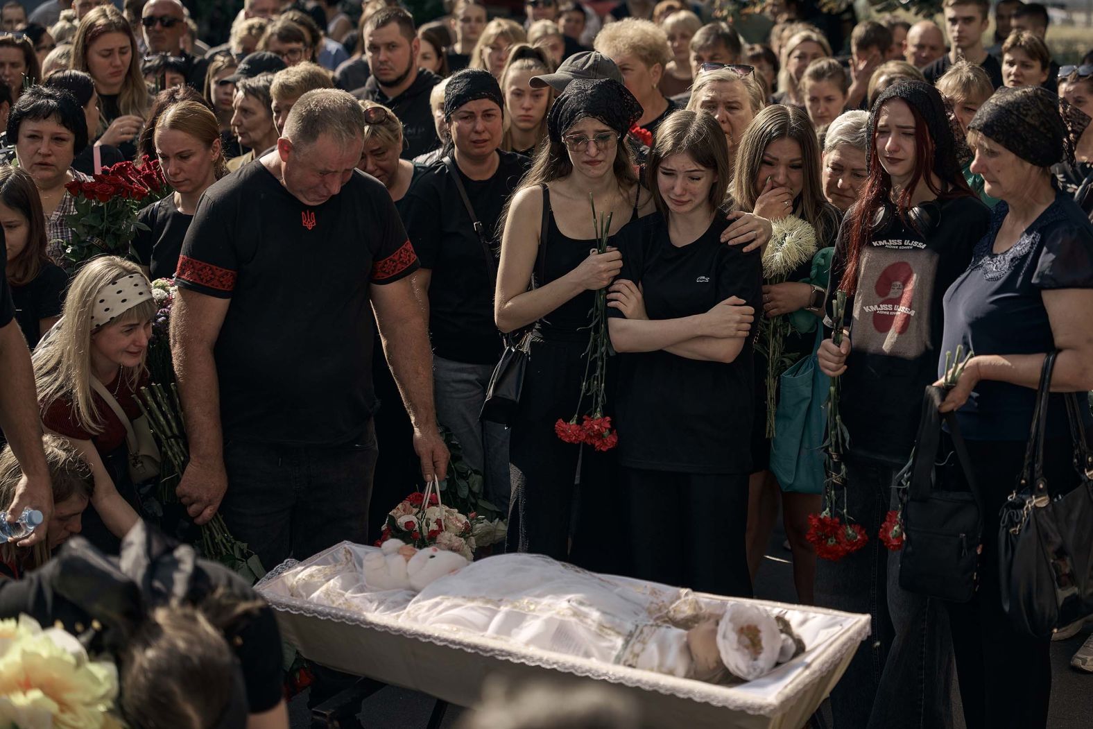 People in Kyiv, Ukraine, cry during the funeral of 24-year-old Nadiia and her 2-year-old daughter, Angelina, on Sunday, August 31. The young mother and her child were killed in a <a href="index.php?page=&url=https%3A%2F%2Fwww.cnn.com%2F2025%2F08%2F28%2Feurope%2Fukraine-russia-kyiv-attack-hnk-intl">Russian missile strike</a> on August 28.