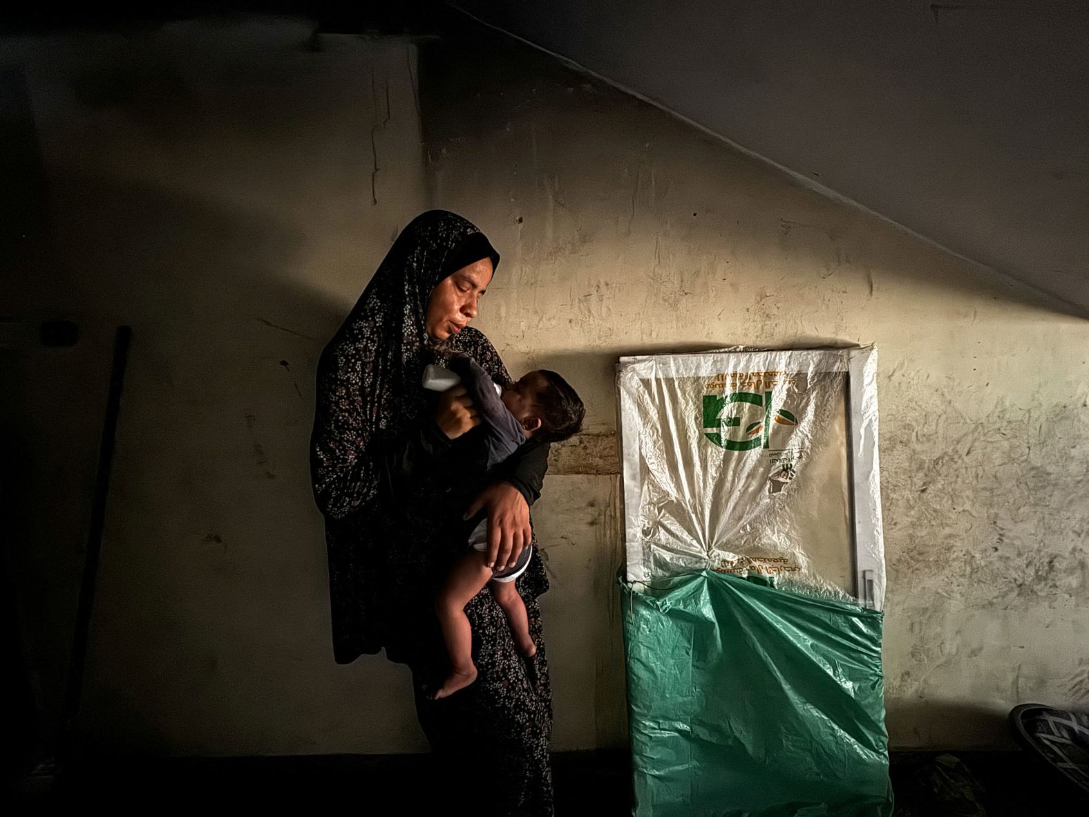 A displaced Palestinian woman feeds her son milk at a shelter in Khan Younis, Gaza, on Wednesday, June 26. A report published Tuesday by the Integrated Food Security Phase Classification, which assesses global food insecurity and malnutrition, <a href="index.php?page=&url=https%3A%2F%2Fwww.cnn.com%2F2024%2F06%2F25%2Fmiddleeast%2Fisrael-gaza-children-starvation-malnutrition-intl%2Findex.html">warned that almost all of Gaza will face famine within the next three months</a>.