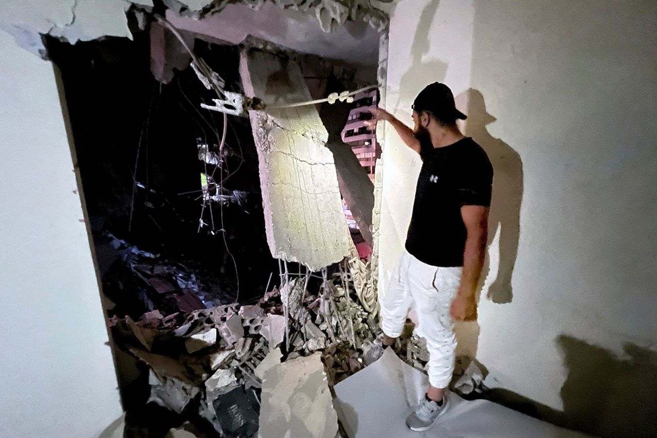 A man inspects a damaged building that was hit by an Israeli airstrike in the southern suburbs of Beirut on Tuesday.