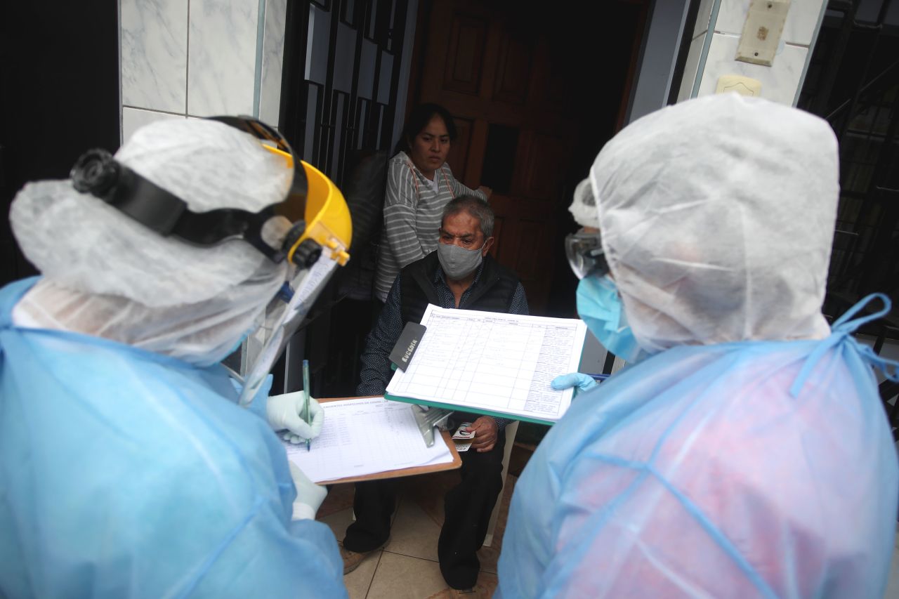 Residents await the results of a rapid test during a house-to-house coronavirus testing drive on July 21 in Lima, Peru. 