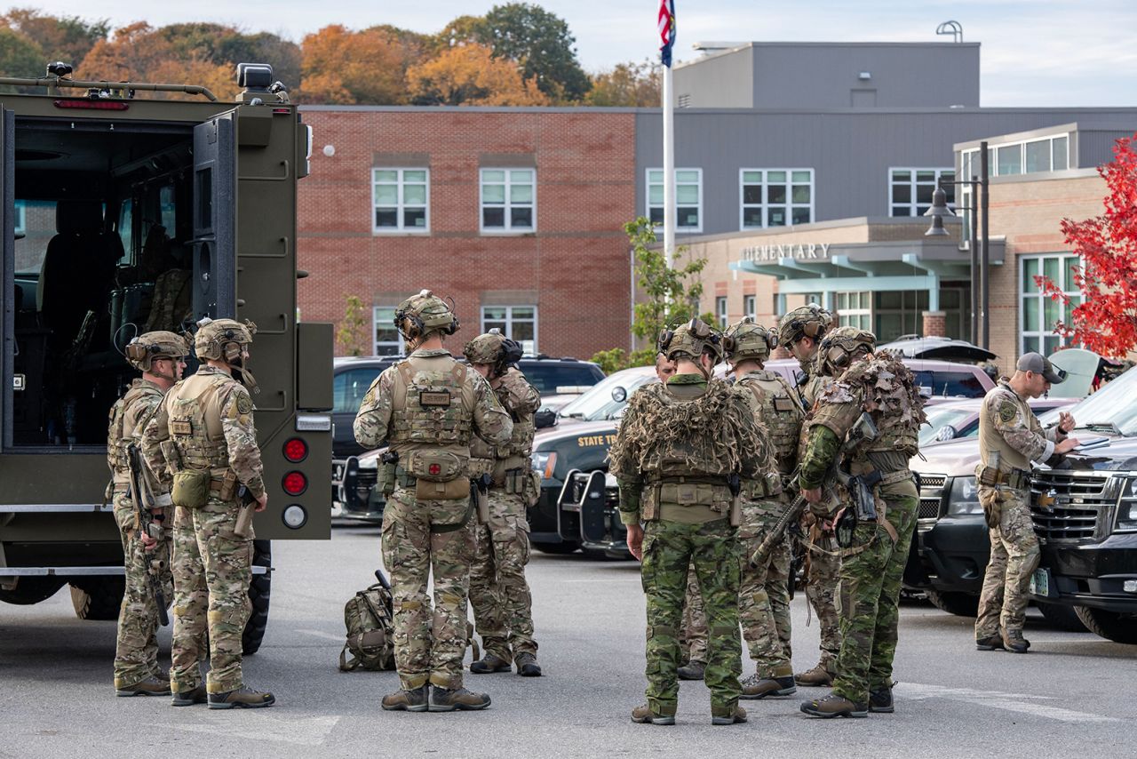 Law enforcement officers gather in Lewiston, Maine, on October 26. 