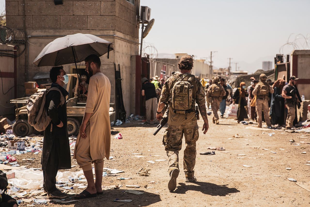 In this image provided by the U.S. Marine Corps, a Canadian coalition forces member walks through an evacuation control checkpoint during ongoing evacuations at Hamid Karzai International Airport in Kabul on Tuesday, August 24.