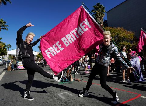 Twins Edward, right, and John Grimes of Dublin, Ireland, pose with a "Free Britney" flag.