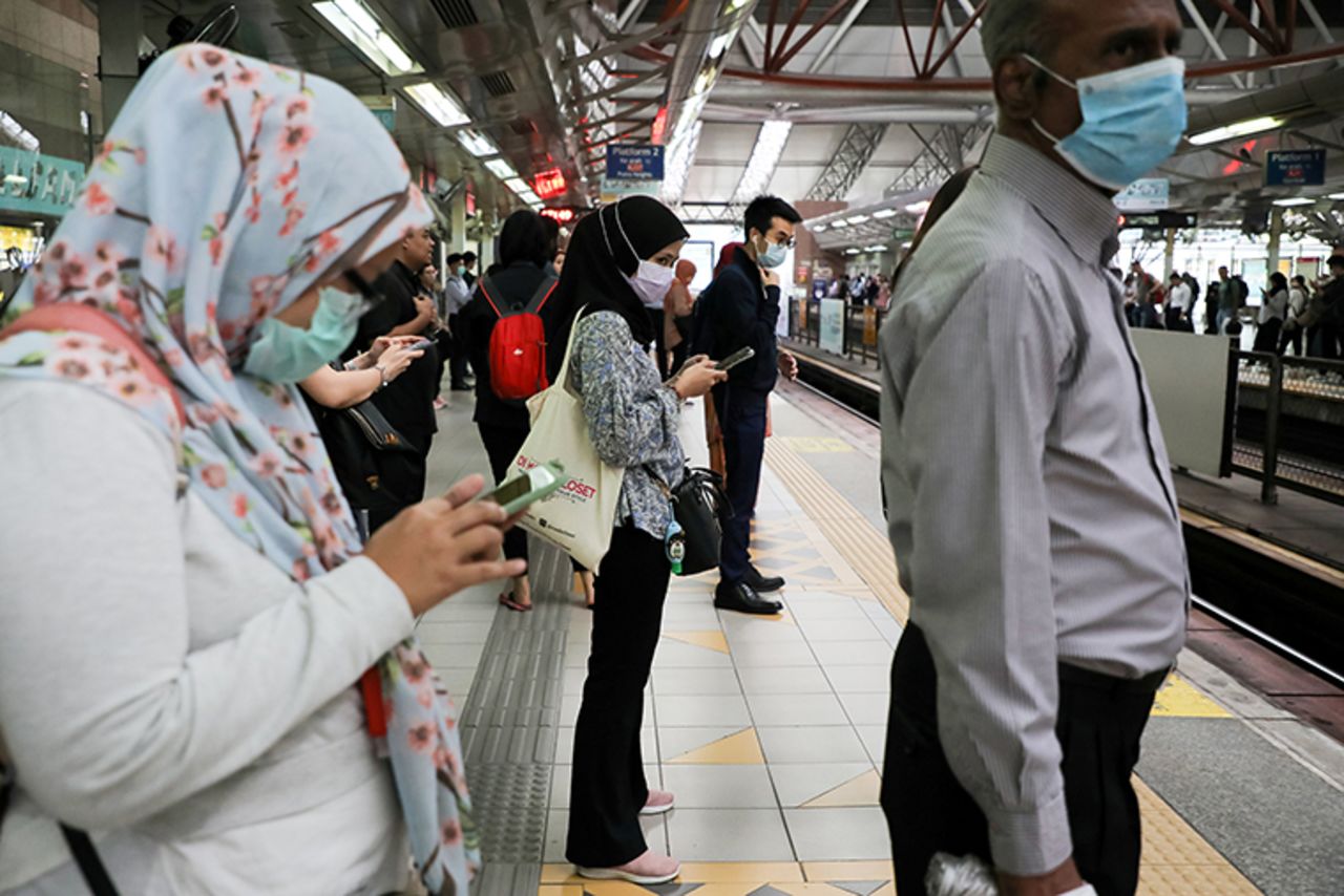 Passengers wear protective masks while they wait for a train, following the outbreak of the new coronavirus in China, in Kuala Lumpur, Malaysia, on February 10. 