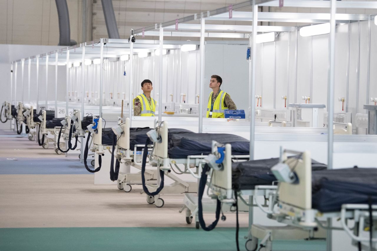 Soldiers and private contractors prepare a temporary hospital for coronavirus victims in London on March 30.