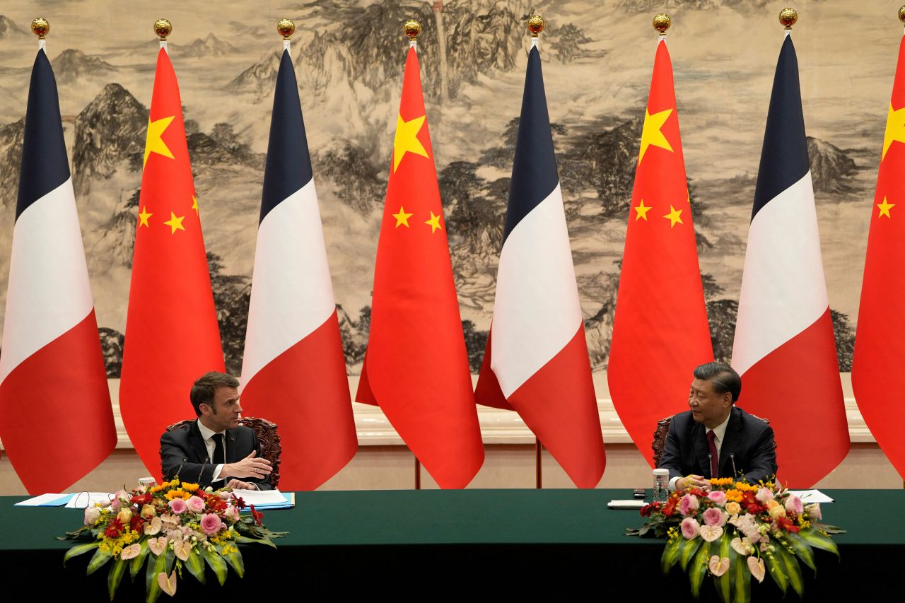 French President Emmanuel Macron, left, looks over to Chinese President Xi Jinping during a joint meeting at the Great Hall of the People in Beijing on Thursday.