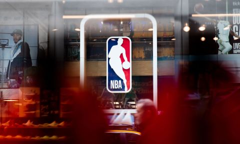 Pedestrians walk past an NBA store on March 12 in New York City.