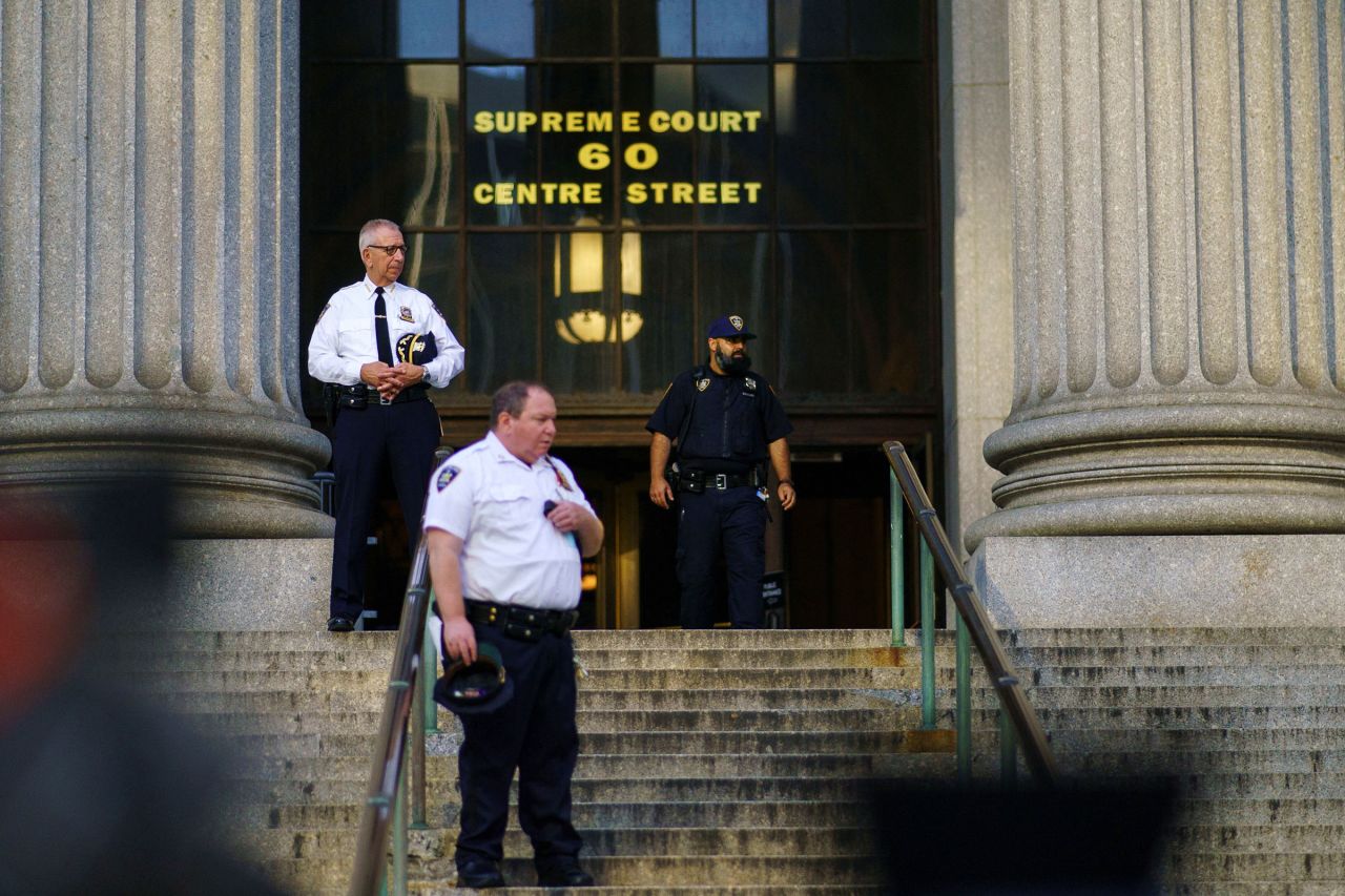 Law enforcement officers stand outside a Manhattan courthouse ahead of the start of the trial of former President Donald Trump, his adult sons, the Trump Organization and others in a civil fraud case brought by state Attorney General Letitia James, in New York City, on Monday.