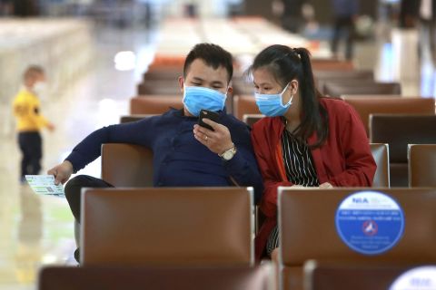 Passengers sit at a departure lounge at Hanoi airport in Hanoi, Vietnam, on Thursday, May 7. 