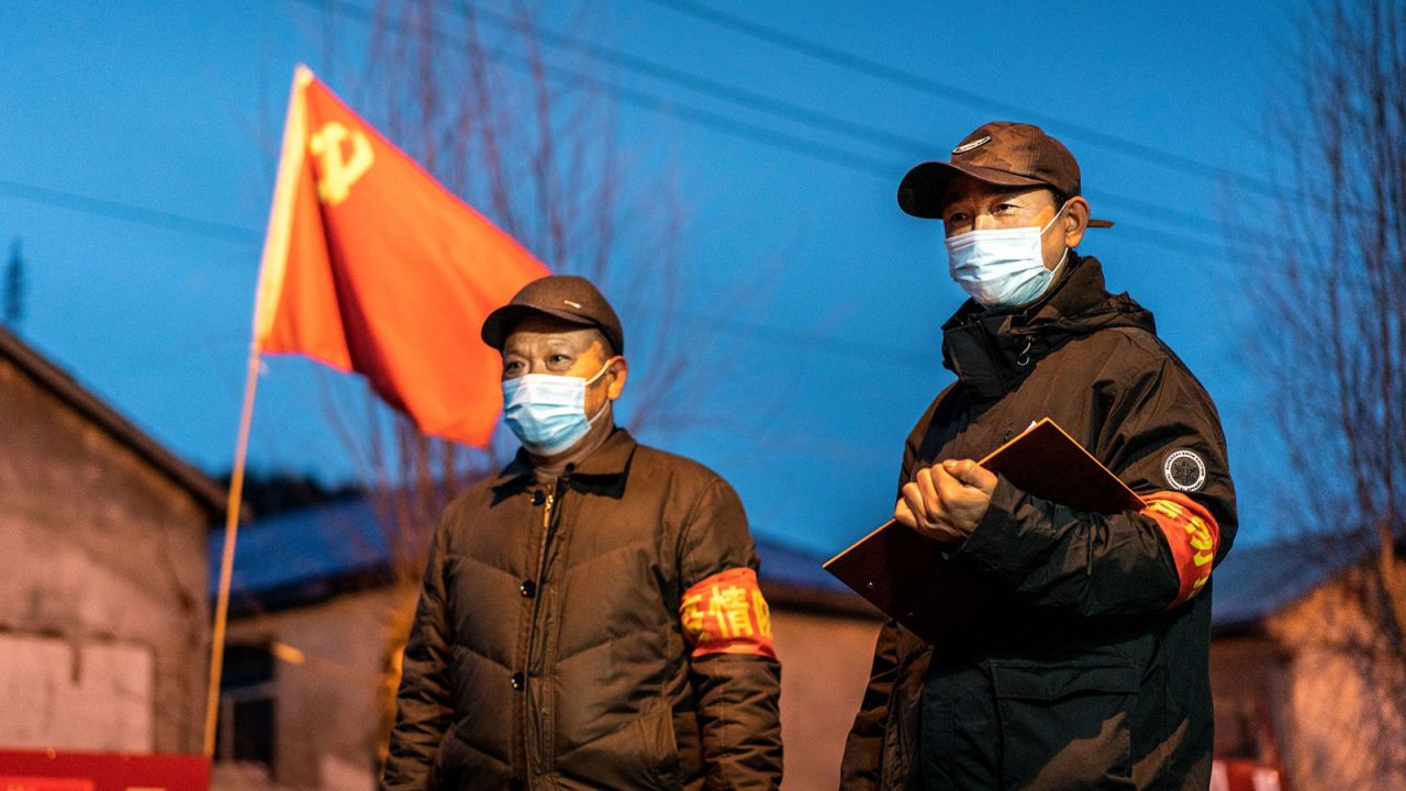 This photo taken on April 21, 2020 shows officials keeping watch at a checkpoint in the border city of Suifenhe, in China's northeastern Heilongjiang province. A cluster of coronavirus cases in the provincial capital Harbin has forced officials to tighten restrictions on movement.