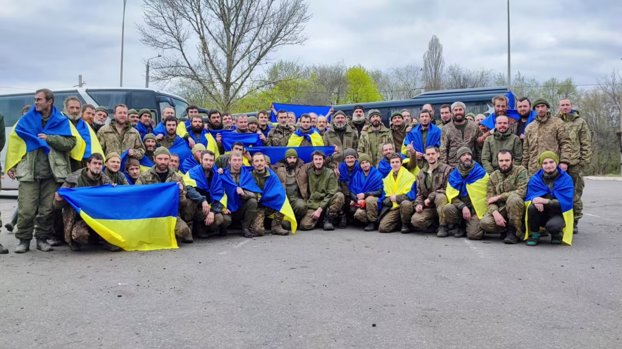 Ukrainian prisoners pose for a picture after a prisoner exchange, in this handout photo released April 16.