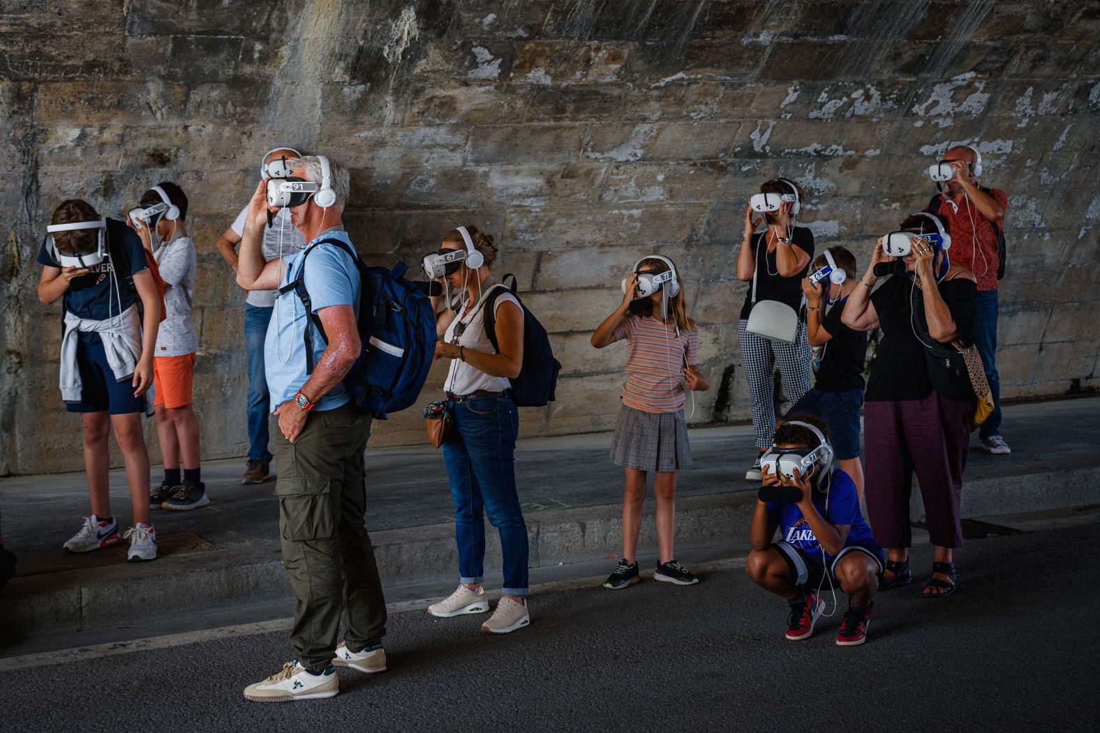 Tourists use augmented reality glasses under the Pont Neuf bridge in Paris on Thursday, August 21.