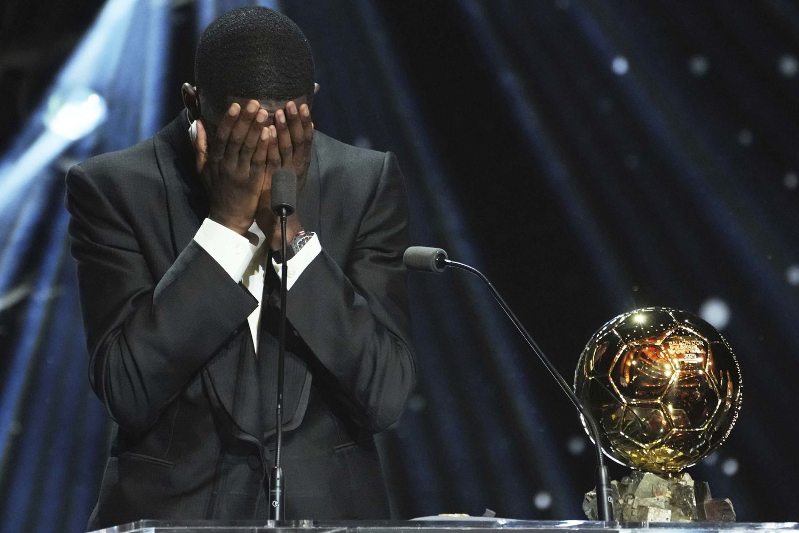 Paris Saint-Germain star Ousmane Dembélé reacts as he <a href="index.php?page=&url=https%3A%2F%2Fwww.cnn.com%2F2025%2F09%2F22%2Fsport%2Fsoccer-ballon-dor-ousmane-dembele-aitana-bonmati">receives the Ballon d'Or trophy</a> on Monday, September 22. Dembélé had a brilliant season for the French club, scoring 35 times as they won the European treble.