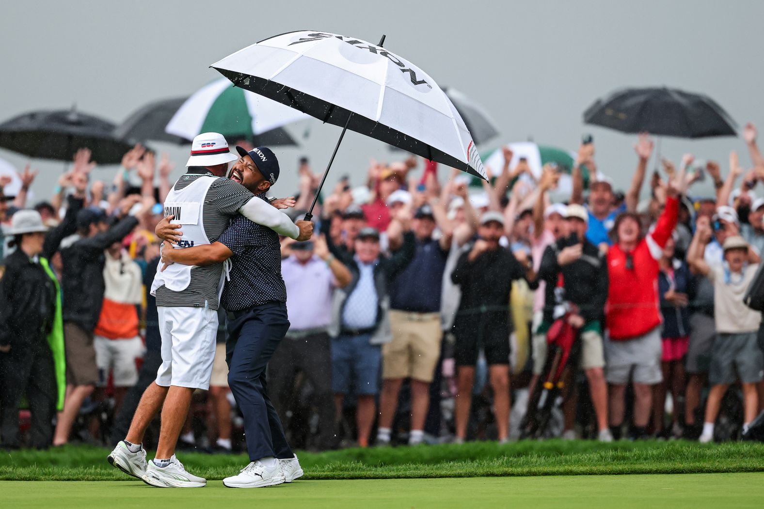 J.J. Spaun celebrates with his caddie, Mark Carens, after sinking a long putt <a href="index.php?page=&url=https%3A%2F%2Fwww.cnn.com%2F2025%2F06%2F15%2Fsport%2Fus-open-final-round-spt">to win the US Open</a> in Oakmont, Pennsylvania, on Sunday, June 15. It is the first major title of his career.