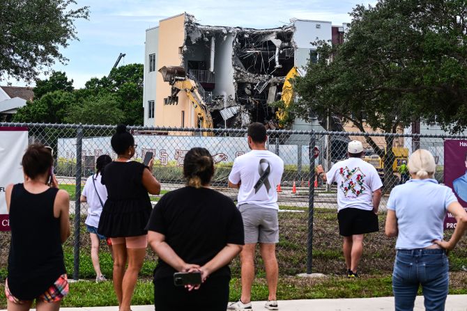 People watch on Friday, June 14, as crews begin to <a href=