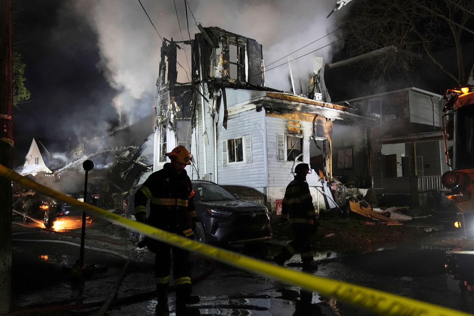 Firefighters work at the scene of a house fire in East Lansdowne, Pennsylvania, on Wednesday, February 7. <a href="index.php?page=&url=https%3A%2F%2Fwww.cnn.com%2F2024%2F02%2F07%2Fus%2Factive-shooter-officers-injured-pennsylvania-house%2Findex.html">At least six members of a family remained unaccounted for Thursday</a>, a day after police responded to the house after a report that a child had been shot there, a district attorney said. Two officers were hit by gunfire after responding. Investigators have recovered a torso and a rifle from the home, the district attorney said Thursday.