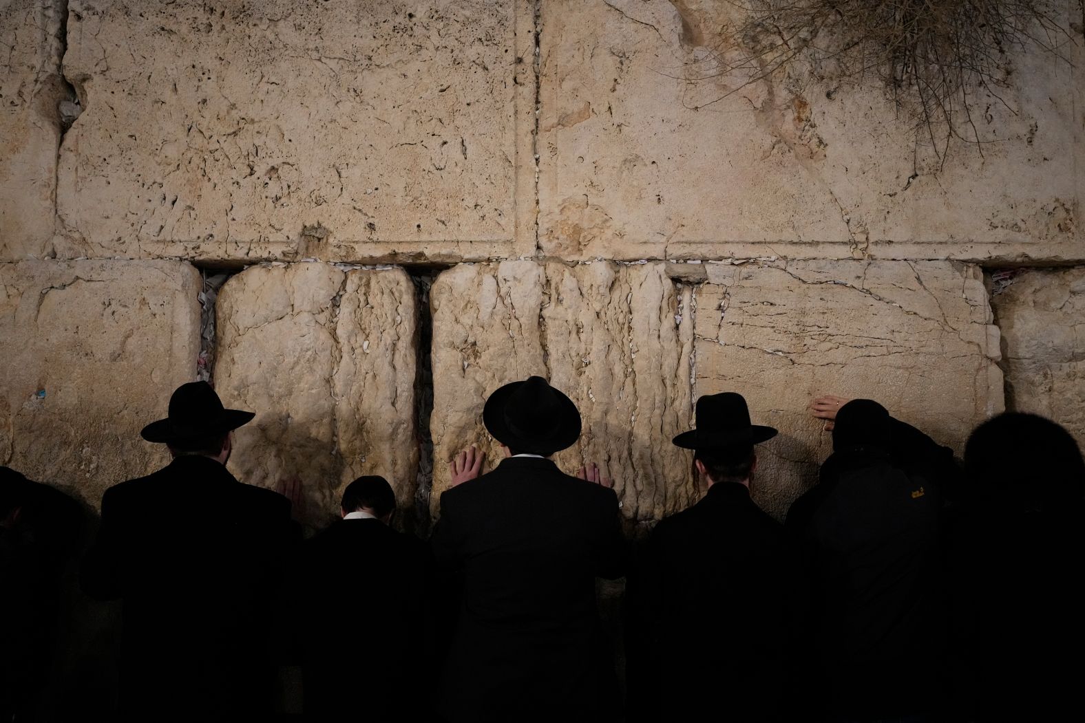 Ultra-Orthodox Jewish men pray at the Western Wall in Jerusalem’s Old City on Sunday, December 29. It was the fifth night of the Hanukkah holiday.