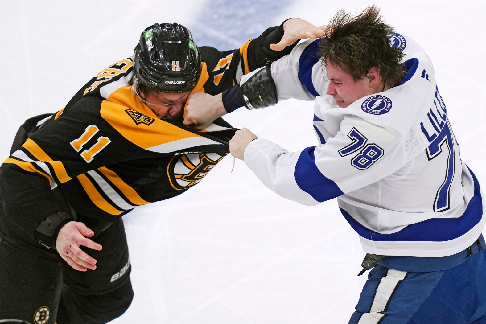 Tampa Bay Lightning defenseman Emil Lilleberg punches Boston Bruins center Trent Frederic during an NHL game in Boston on Tuesday, January 14.