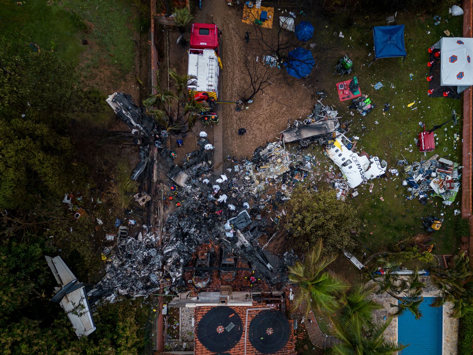 Debris lies at the site of a plane crash in Vinhedo, Brazil, on Saturday, August 10. The passenger plane crashed outside S?o Paulo the day before, <a >killing everyone on board</a> after dropping 17,000 feet in just one minute.