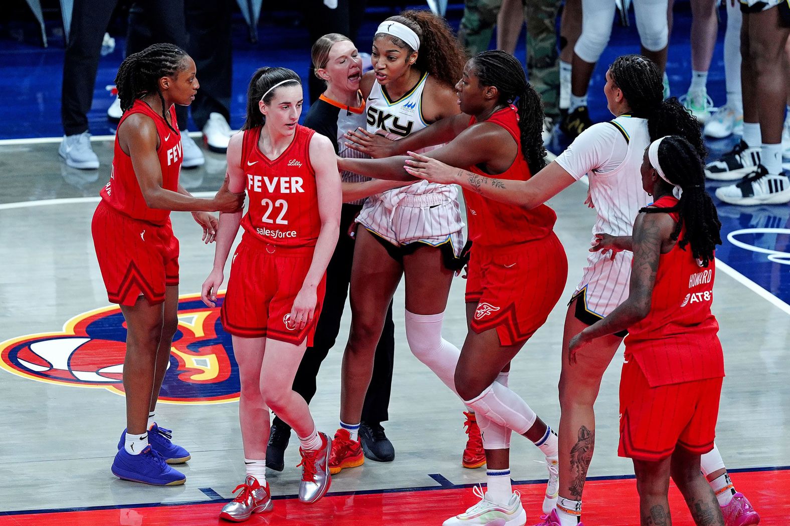 Chicago Sky forward Angel Reese is held back from Indiana Fever guard Caitlin Clark after Clark knocked Reese to the ground with a hard foul on Saturday, May 17. Clark was called for a <a href="https://www.cnn.com/2025/05/18/sport/caitlin-clark-triple-double-angel-reese-spt">flagrant foul</a> on the play.
