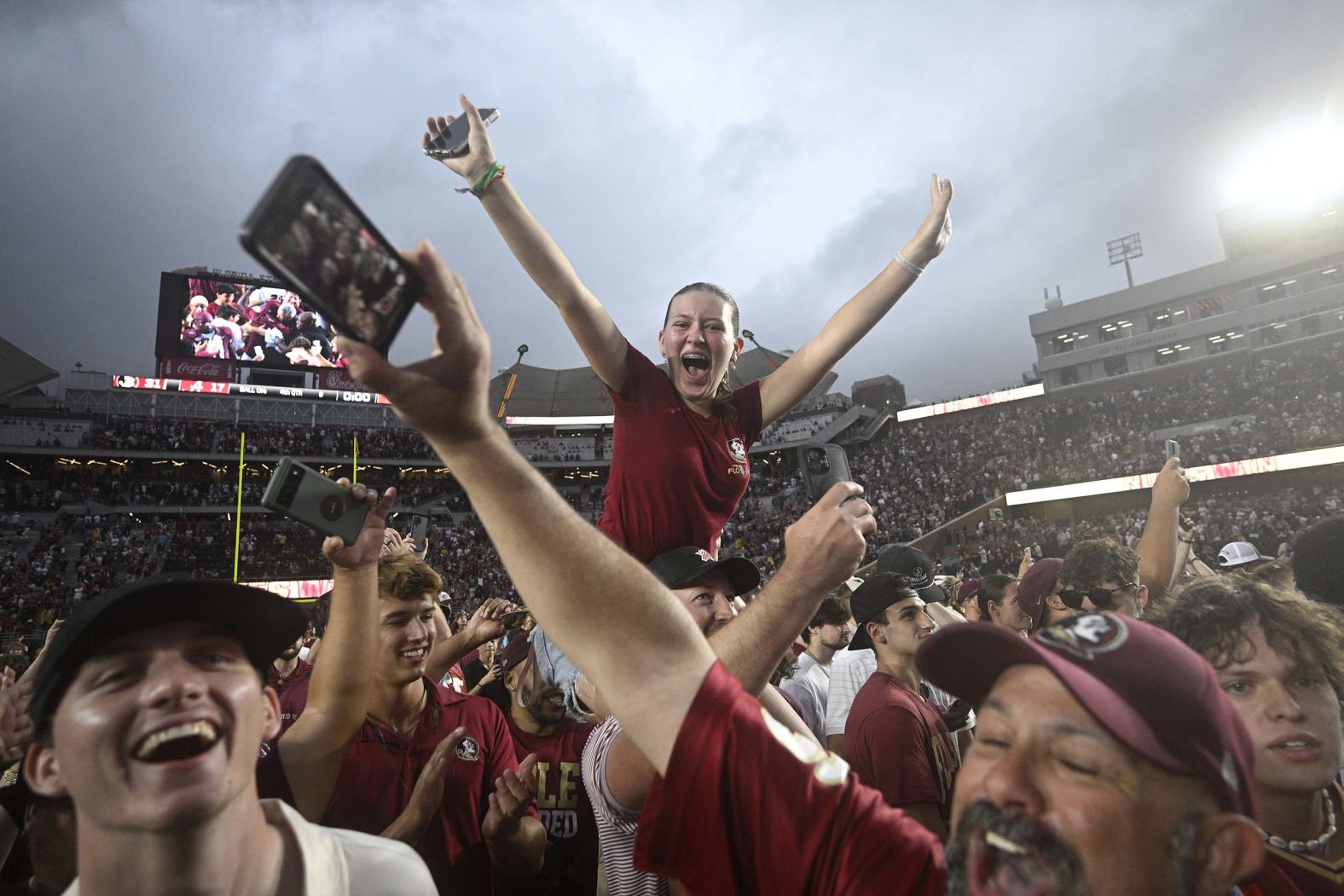Florida State fans celebrate on the field after their football team upset No. 8 Alabama 31-17 on Saturday, August 30.