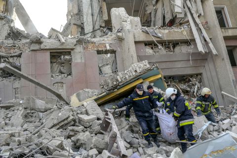 Firefighters carry a body from the rubble of a government building hit by a Russian strike in Mykolaiv, Ukraine on March 29. 