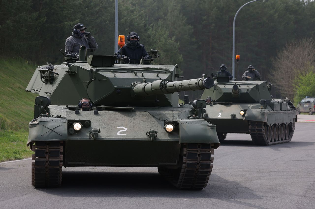 Leopard 1A5 main battle tanks arrive at a military training ground where Ukrainian tank crews are being trained to operate and maintain them by German and Danish military personnel on May 5, near Klietz, Germany. 