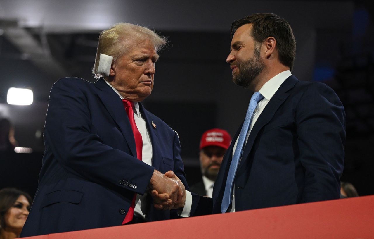 Former President Donald Trump and his running mate, Sen. JD Vance, shake hands during the Republican National Convention in Milwaukee on Monday night.