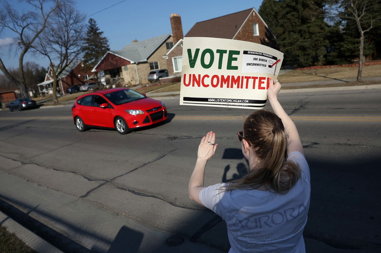 A demonstrator holds a sign urging people to vote uncommitted on February 27, in Dearborn, Michigan. 