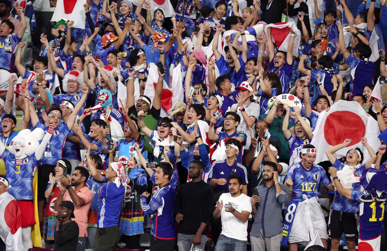 Japan fans celebrate their team's 2-1 victory against Germany at the Khalifa International Stadium in Doha, Qatar on Wednesday.