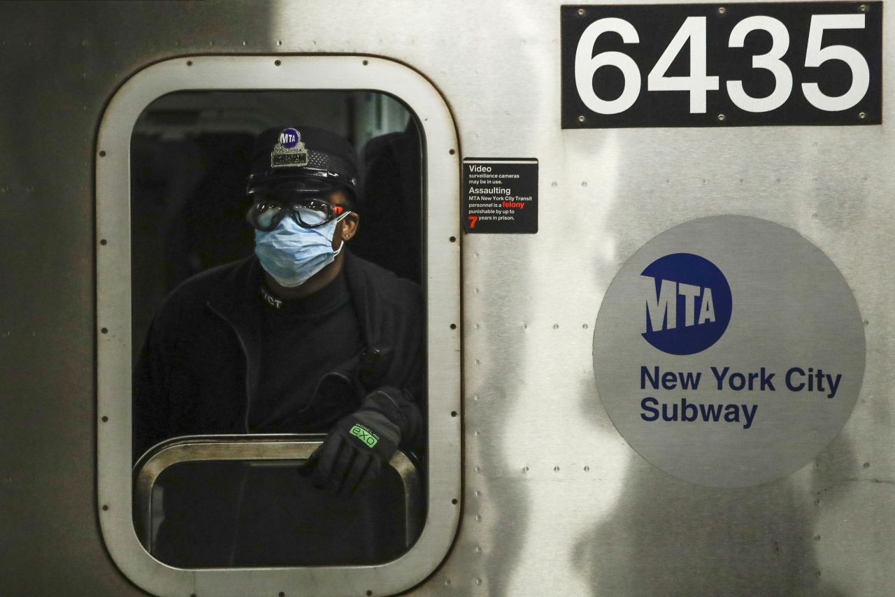 A Metropolitan Transportation Authority worker wears a face mask at the Grand Army Plaza station in Brooklyn, New York, on April 7.