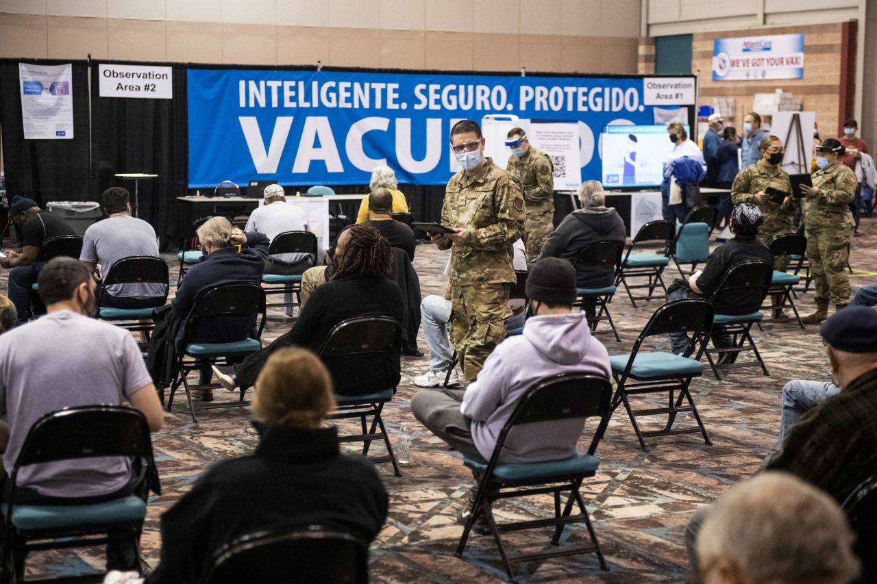 A member of the National Guard checks on people after they received a Covid-19 vaccine at the Atlantic County vaccination megasite in Atlantic City, New Jersey, on April 8.