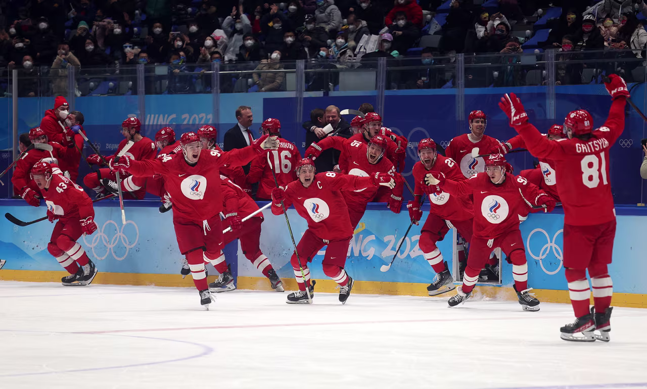 The Russian Olympic Committee hockey team celebrates after defeating Sweden in a penalty shootout on February 18.