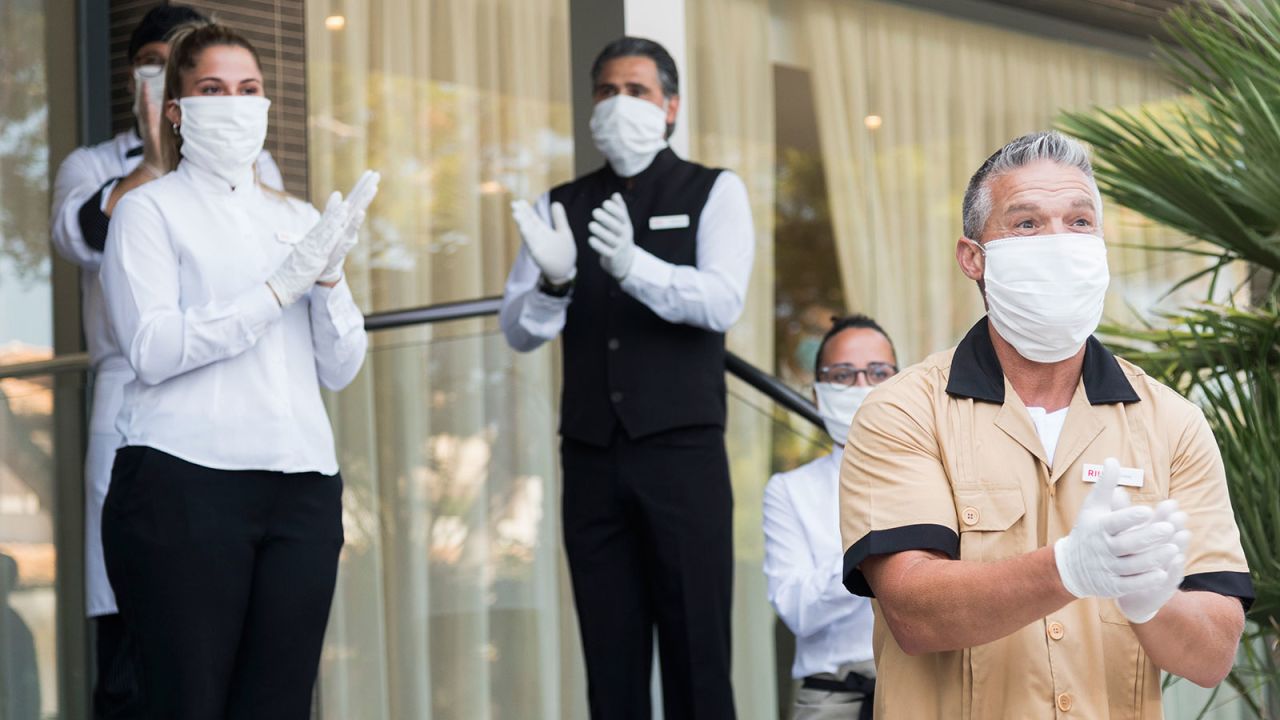 Workers of the RIU Hotel in Mallorca welcome guests from Germany on June 15. 