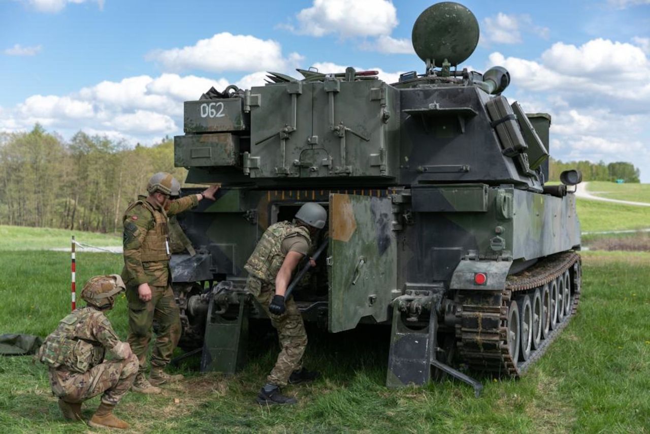Ukrainian artillerymen load an M109 self-propelled howitzer during training exercises with US and Norwegian at Grafenwoehr Training Area on May 12.