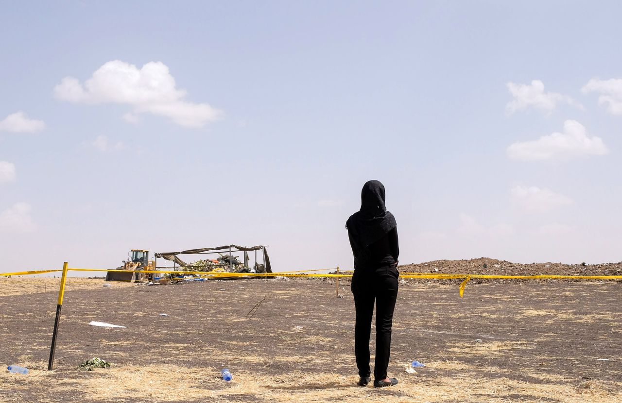 A mourner arrives to pay her respects at the crash site of Ethiopian Airlines Flight ET302 on March 14, 2019 in Ejere, Ethiopia. All 157 passengers and crew perished after the Ethiopian Airlines Boeing 737 Max 8 Flight came down six minutes after taking off from Bole Airport. 