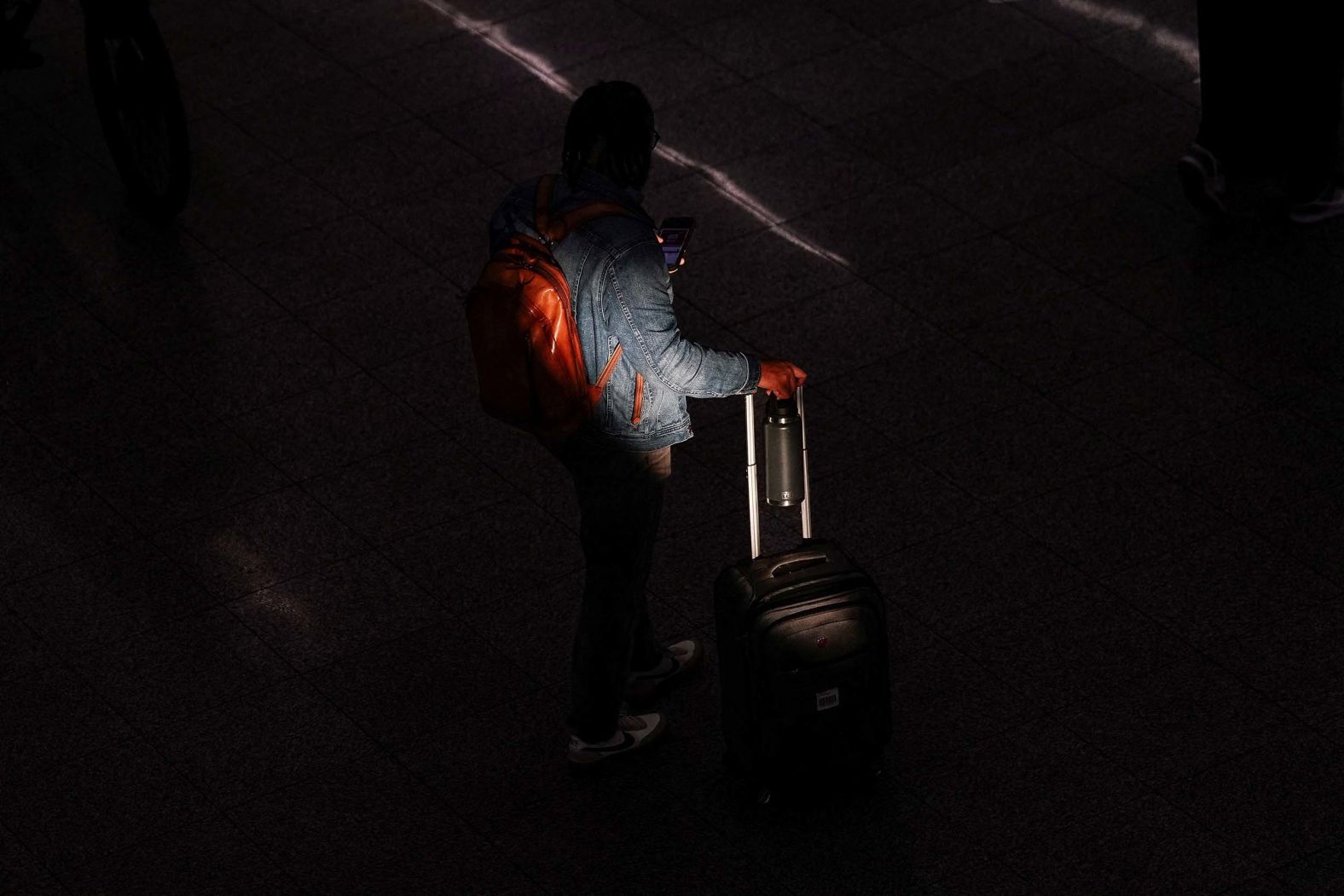 A traveler is obscured by a shadow at Hartsfield–Jackson Atlanta International Airport on Thursday, November 6. Starting Friday, the Federal Aviation Administration is <a href="index.php?page=&url=https%3A%2F%2Fwww.cnn.com%2F2025%2F11%2F05%2Fus%2Fairport-traffic-cuts-government-shutdown">reducing flights at dozens of major airports</a>. The move comes during the government shutdown, which has led to a shortage in air traffic controllers.