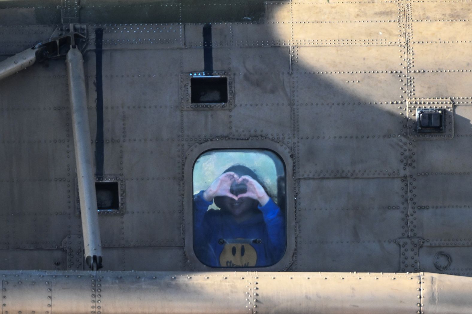 Liri Albag, an Israeli soldier who was seized from her army base in southern Israel during Hamas’ attack on Israel in October 7, 2023, makes a heart gesture at the window of a helicopter as she and other <a href="index.php?page=&url=https%3A%2F%2Fwww.cnn.com%2F2025%2F01%2F24%2Fmiddleeast%2Fhamas-israel-hostages-ceasefire-release-intl%2Findex.html">released hostages</a> are transported to a medical complex in Petah Tikva, Israel, on Saturday, January 25.