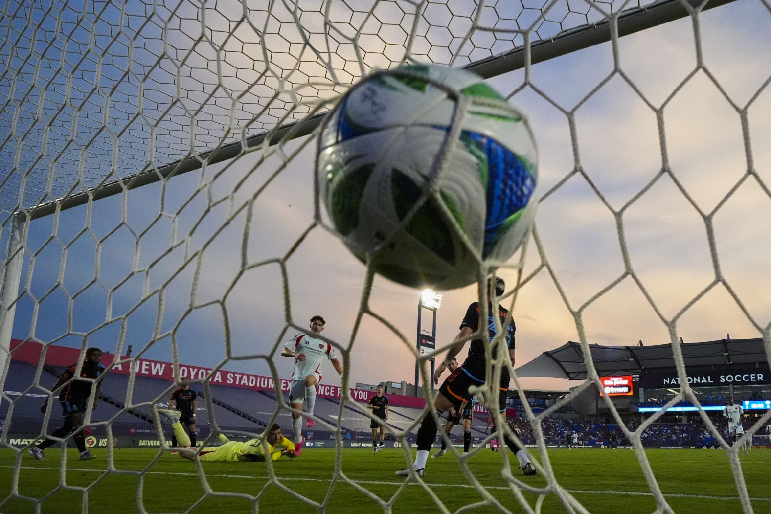 A shot by FC Dallas forward Logan Farrington, center, ripples the net during a home match against New York City FC on Friday, July 25. NYCFC would go on to win 4-3.